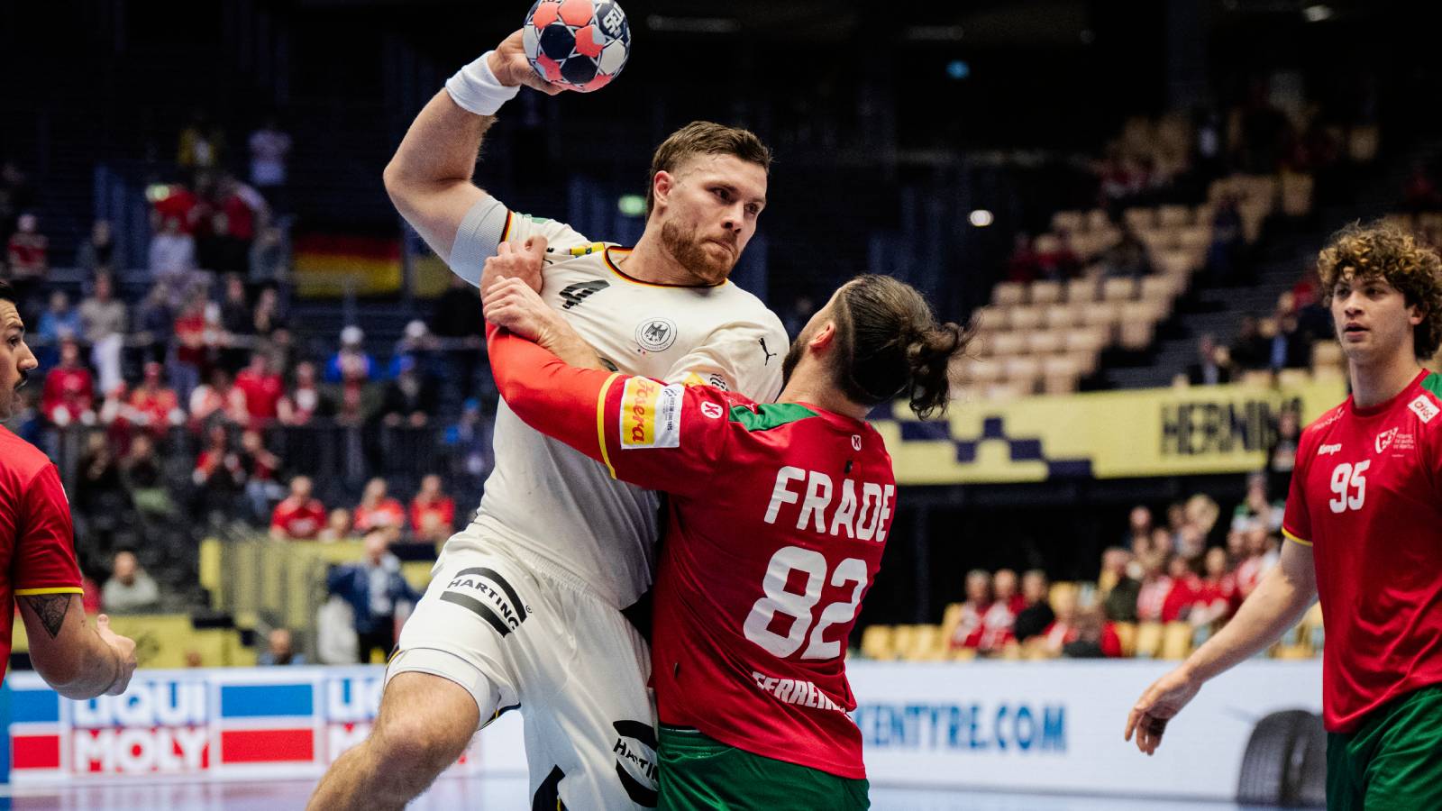 Germany's pivot #04 Johannes Golla and Portugal's pivot #82 Luis Frade vie during the men's EHF Euro 2026 main round handball match Germany vs Portugal in Herning, Denmark, on January 22, 2026.
