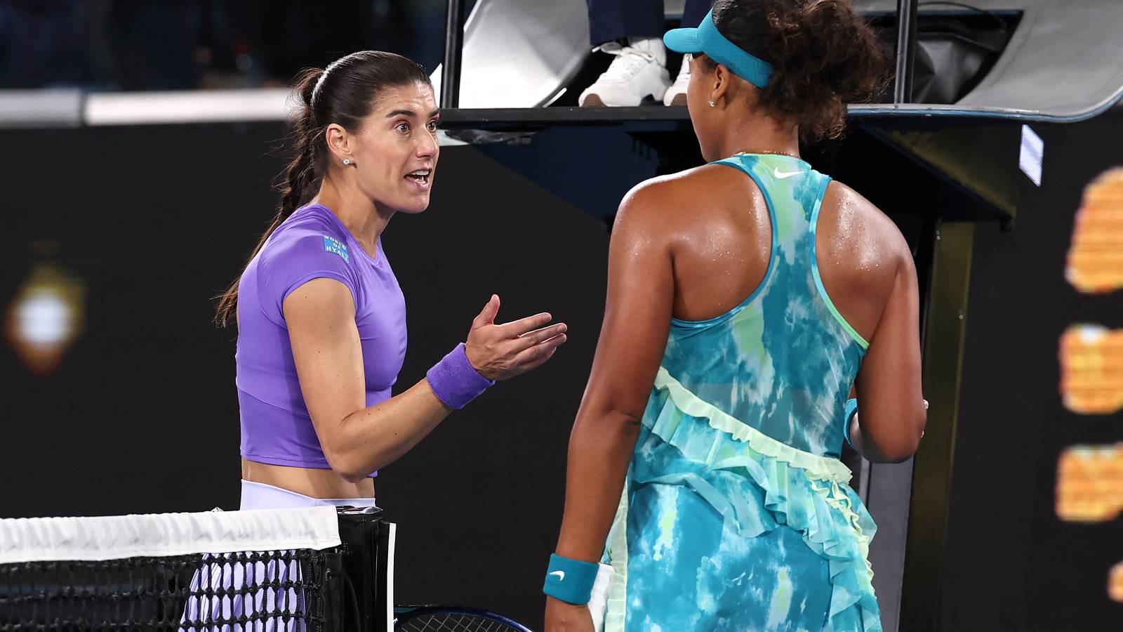 Romania's Sorana Cirstea talks with Japan's Naomi Osaka (R) following their second-round match on day five of the Australian Open tennis tournament in Melbourne on January 22, 2026.