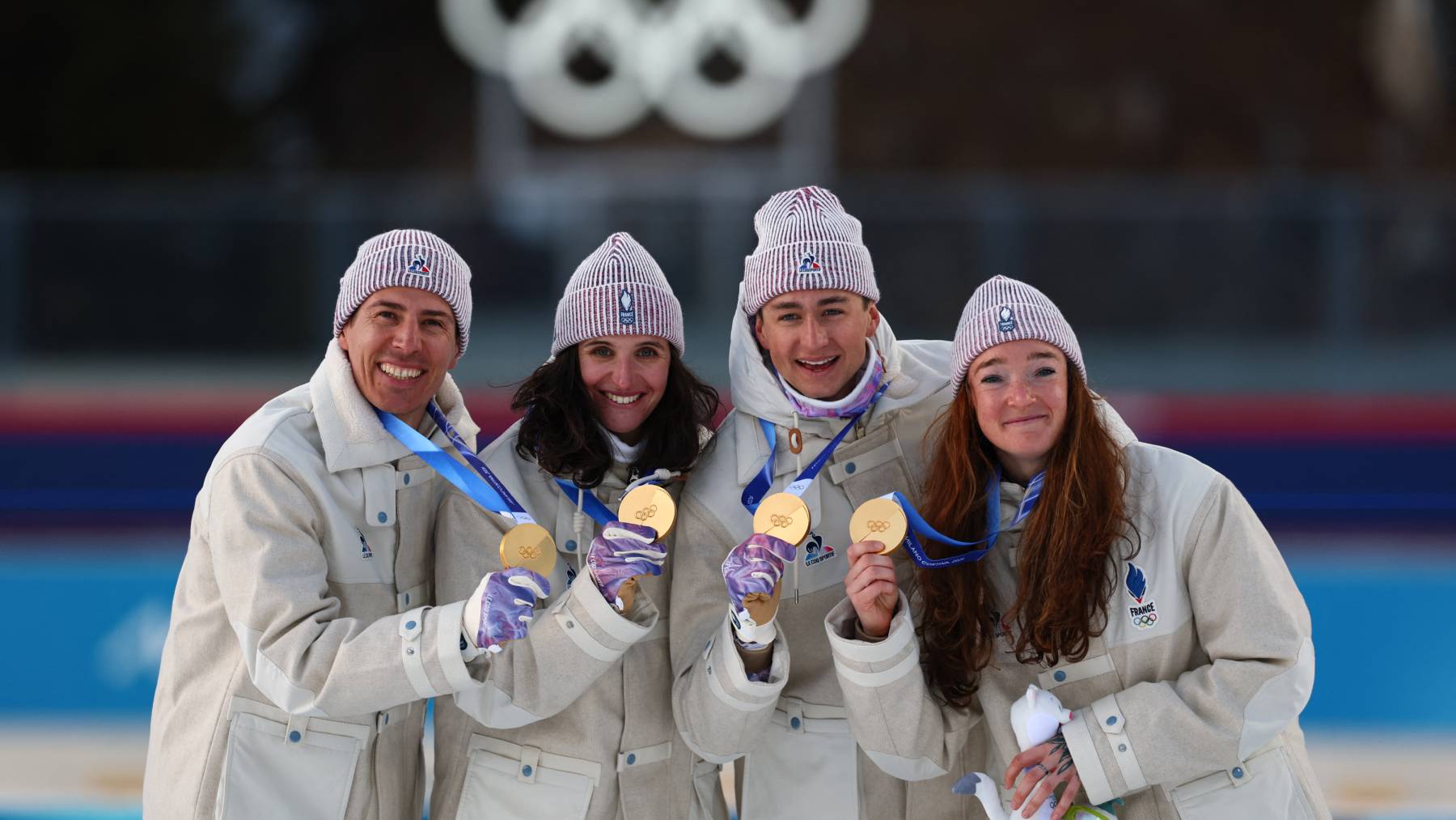 Gold medallists France's Eric Perrot, France's Quentin Fillon Maillet, France's Lou Jeanmonnot, France's Julia Simon pose on the podium of the mixed biathlon 4 x 6km relay event during the Milano Cortina 2026 Winter Olympic Games at the Anterselva Biathlon Arena (Sudtirol Arena) in Anterselva (Val Pusteria) on February 8, 2026.