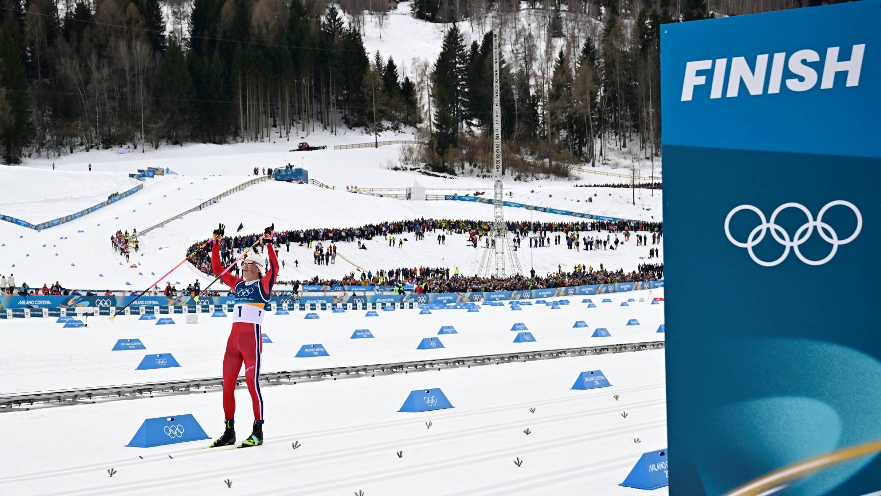 Norway's Johannes Hoesflot Klaebo celebrates as he crosses the finish line to win gold in the men's cross country 50km mass start final event of the Milano Cortina 2026 Winter Olympic Games at Tesero Cross-Country Skiing Stadium in Lago di Tesero (Val di Fiemme) on February 21, 2026.