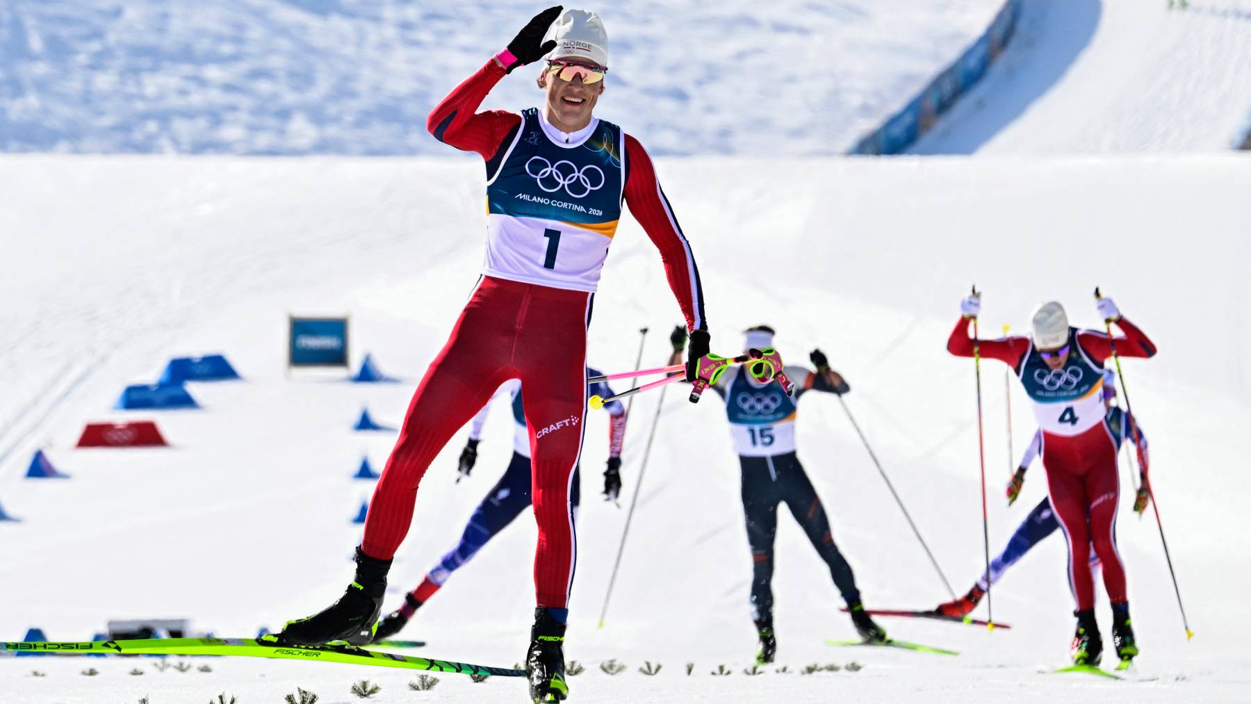 Gold medallist Norway's Johannes Hoesflot Klaebo (L) celebrates after winning during the men's cross country 10km + 10km skiathlon event of the Milano Cortina 2026 Winter Olympic Games at Tesero Cross-Country Skiing Stadium in Lago di Tesero (Val di Fiemme), on February 8, 2026.