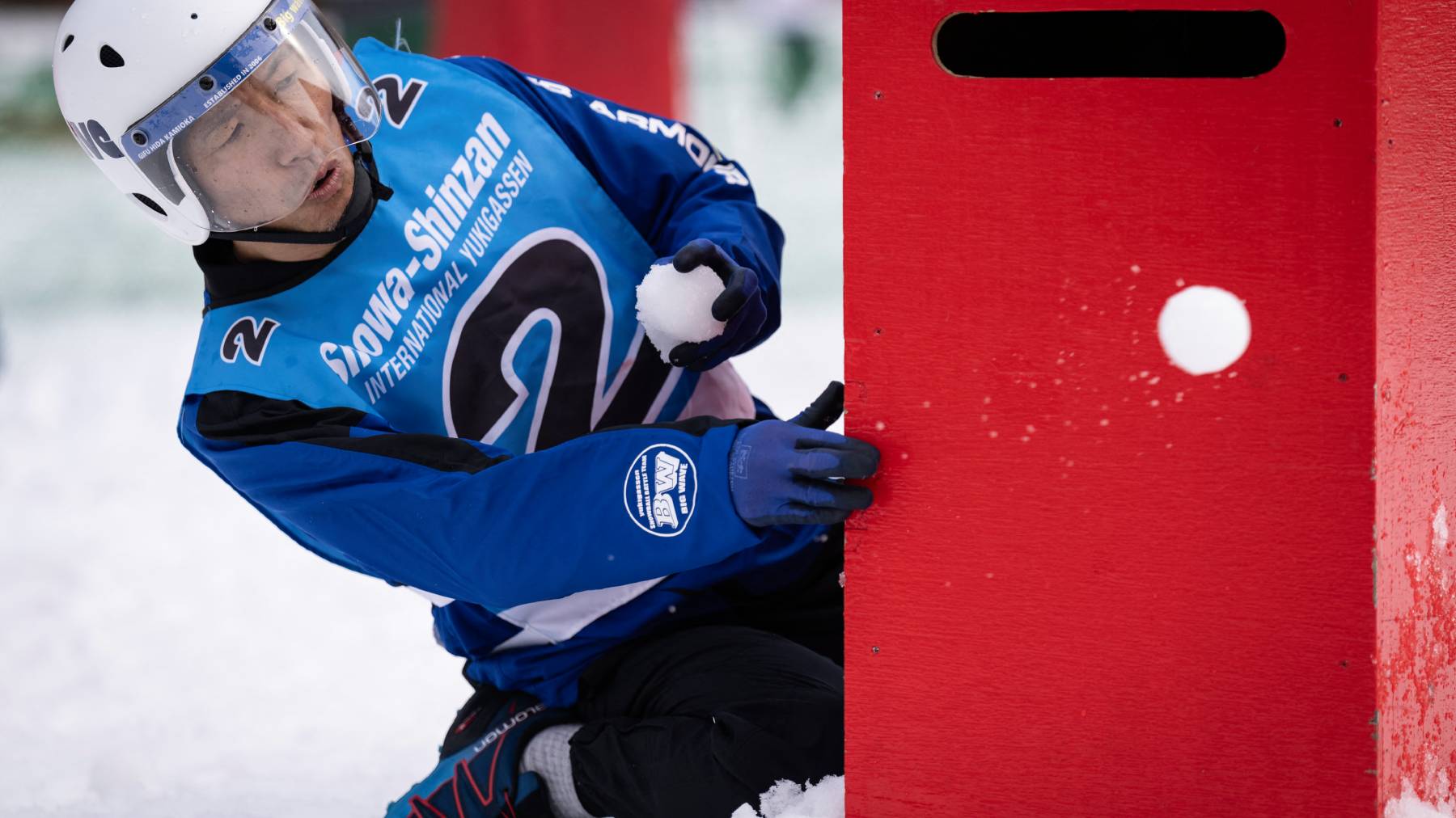 A player throws a snowball during the Showa-shinzan International Yukigassen snowball fight competition in Sobetsu, Hokkaido prefecture on February 21, 2026. At the foot of an active volcano in northern Japan, shouts ring out, competitors size each other up and snowballs whistle through the air in a very serious game of "yukigassen" -- a sport with Olympic dreams.