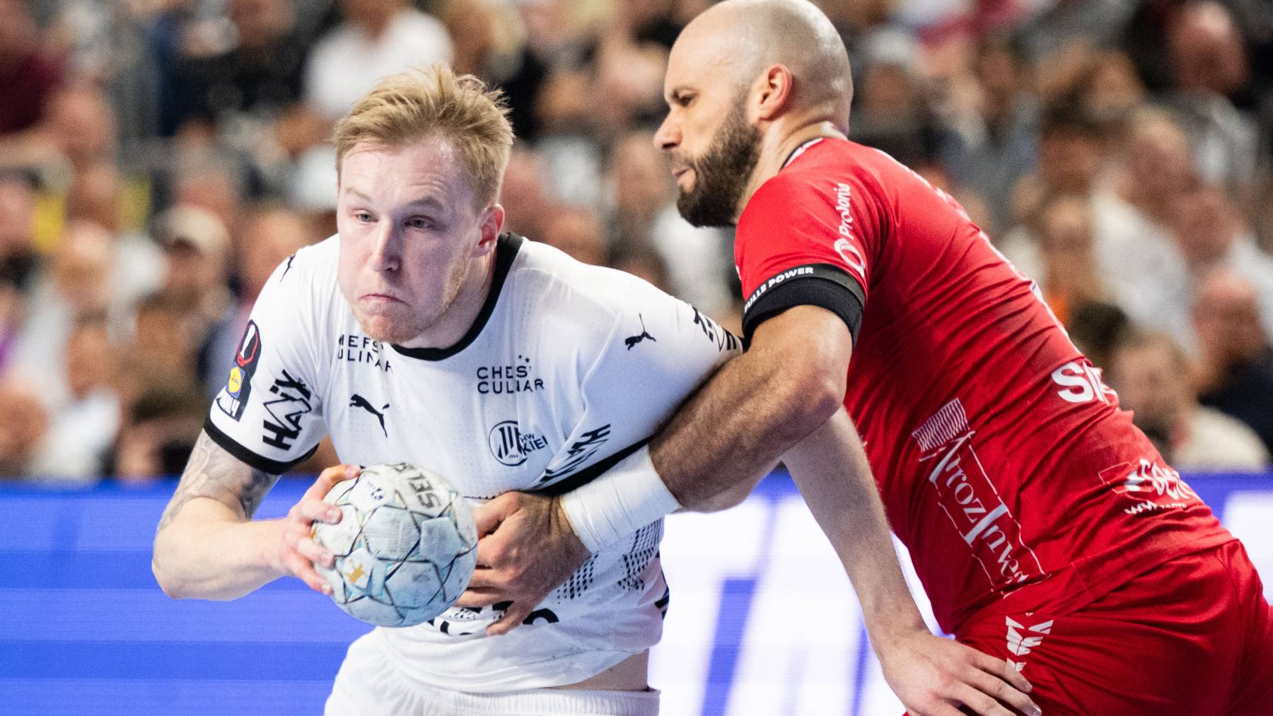 13 April 2025, North Rhine-Westphalia, Cologne: Handball: DHB Cup, THW Kiel - MT Melsungen, Final Four, Final, Lanxess Arena. Melsungen's Adrian Sipos (r) tries to prevent Kiel's Eric Johansson from taking a shot. Photo: Marius Becker/dpa