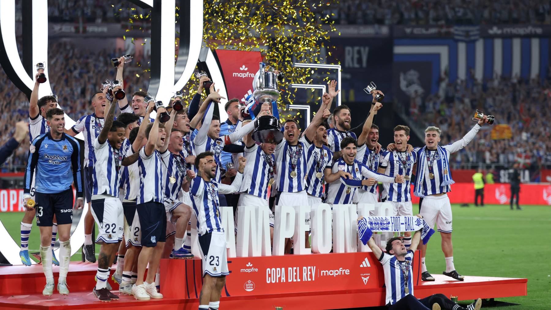 Real Sociedad's players celebrate with the trophy at the end the Copa del Rey (King's Cup) final football match between Club Atletico de Madrid and Real Sociedad at La Cartuja stadium in Seville on April 18, 2026. Real Sociedad won Atletico Madrid 4-3 on penalties.