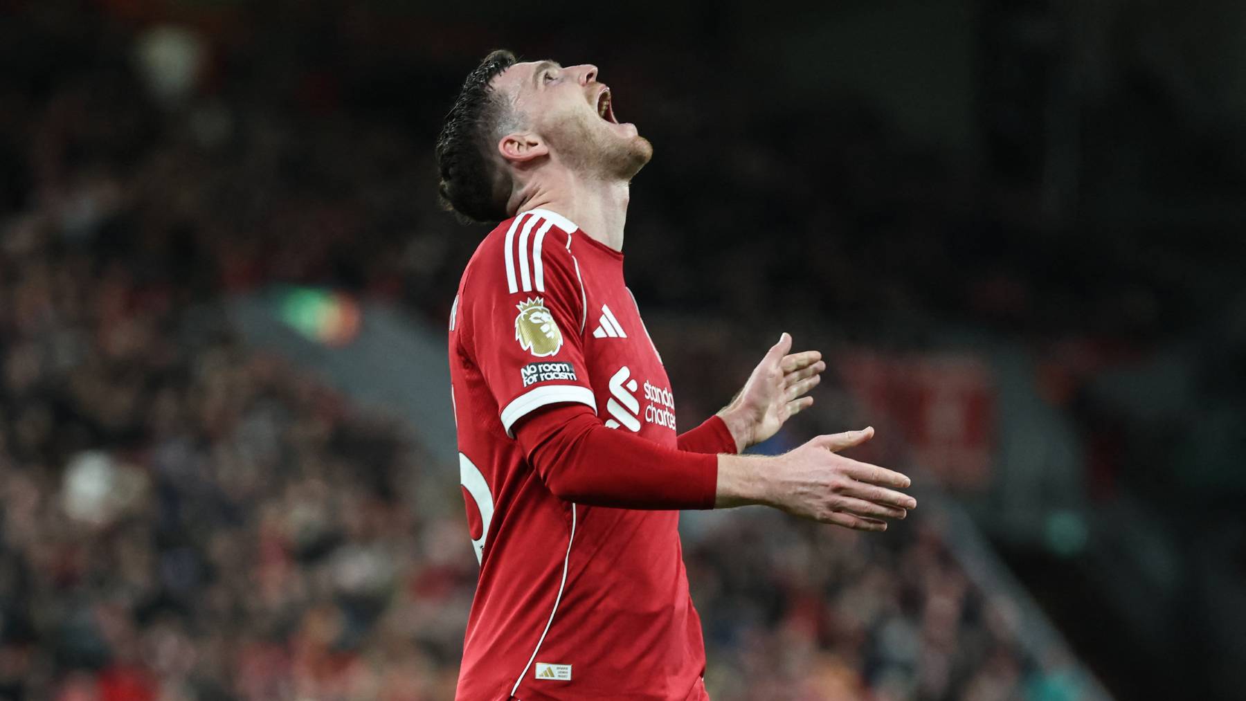 Liverpool's Scottish defender #26 Andrew Robertson reacts after a bad cross during the English Premier League football match between Liverpool and Tottenham Hotspur at Anfield in Liverpool, north west England on March 15, 2026.