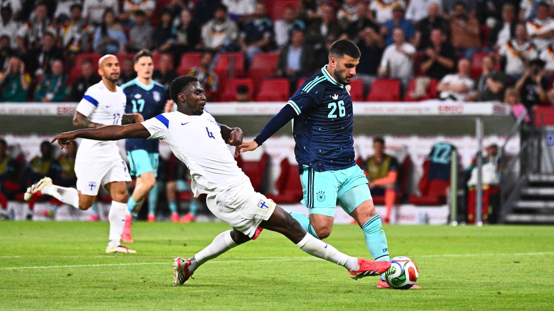 31 May 2026, Rhineland-Palatinate, Mainz: Soccer, men: World Cup preparation, international match before the World Cup finals, Mewa Arena, Deniz Undav (r, Germany) in a duel with Tony Miettinen (Finland) before his goal for 3:0. Photo: Tom Weller/dpa - IMPORTANT NOTE: In accordance with the regulations of the DFL German Football League and the DFB German Football Association, it is prohibited to utilize or have utilized photographs taken in the stadium and/or of the match in the form of sequential images and/or video-like photo series.
