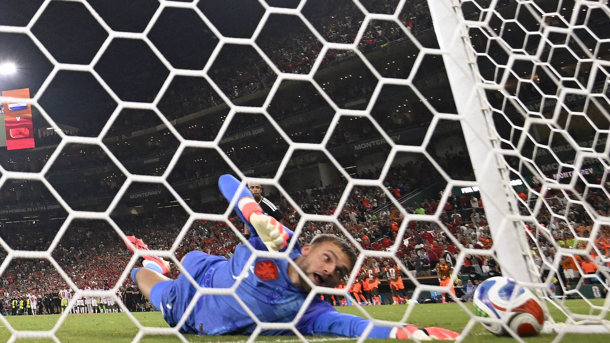Netherlands goalkeeper #01 Bart Verbruggen concedes a penalty goal by Morocco forward #09 Soufiane Rahimi during the penalty shootout of the 2026 World Cup round of 32 football match between the Netherlands and Morocco at the Monterrey Stadium in Guadalupe on June 29, 2026.