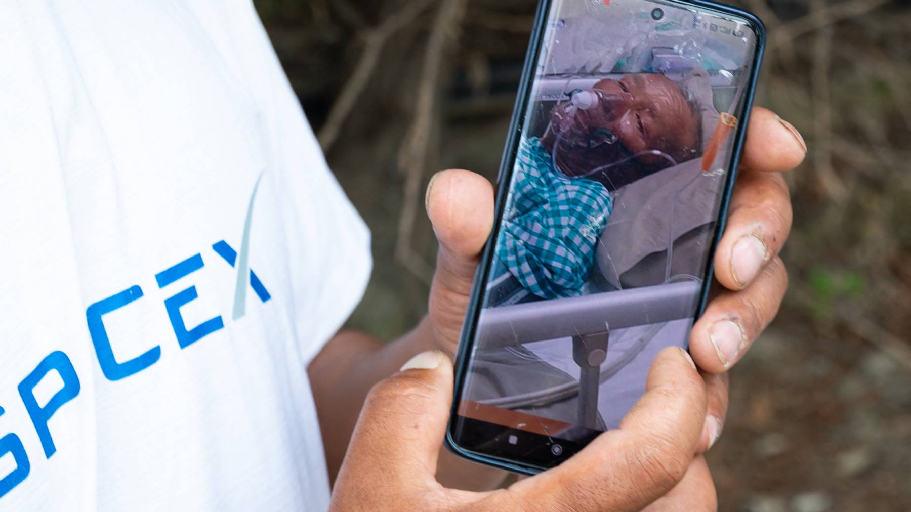 Karma Gyalje Sherpa, an Everest guide and a relative of mountaineer Dawa Sherpa, shows a photograph of Dawa Sherpa undergoing treatment in the intensive care unit (ICU) at HAMS Hospital in Kathmandu on June 5, 2026. The family of a Nepali climber who dragged himself off Mount Everest six days after being abandoned called for an investigation into rescue efforts, as doctors said on June 5 he is in a stable condition and recovering in hospital. Mountaineer Dawa Sherpa, 57, vanished in bitter conditions on the upper reaches of the world's highest mountain early on May 30. His family thought he was dead, and had even begun ritual mourning prayers.