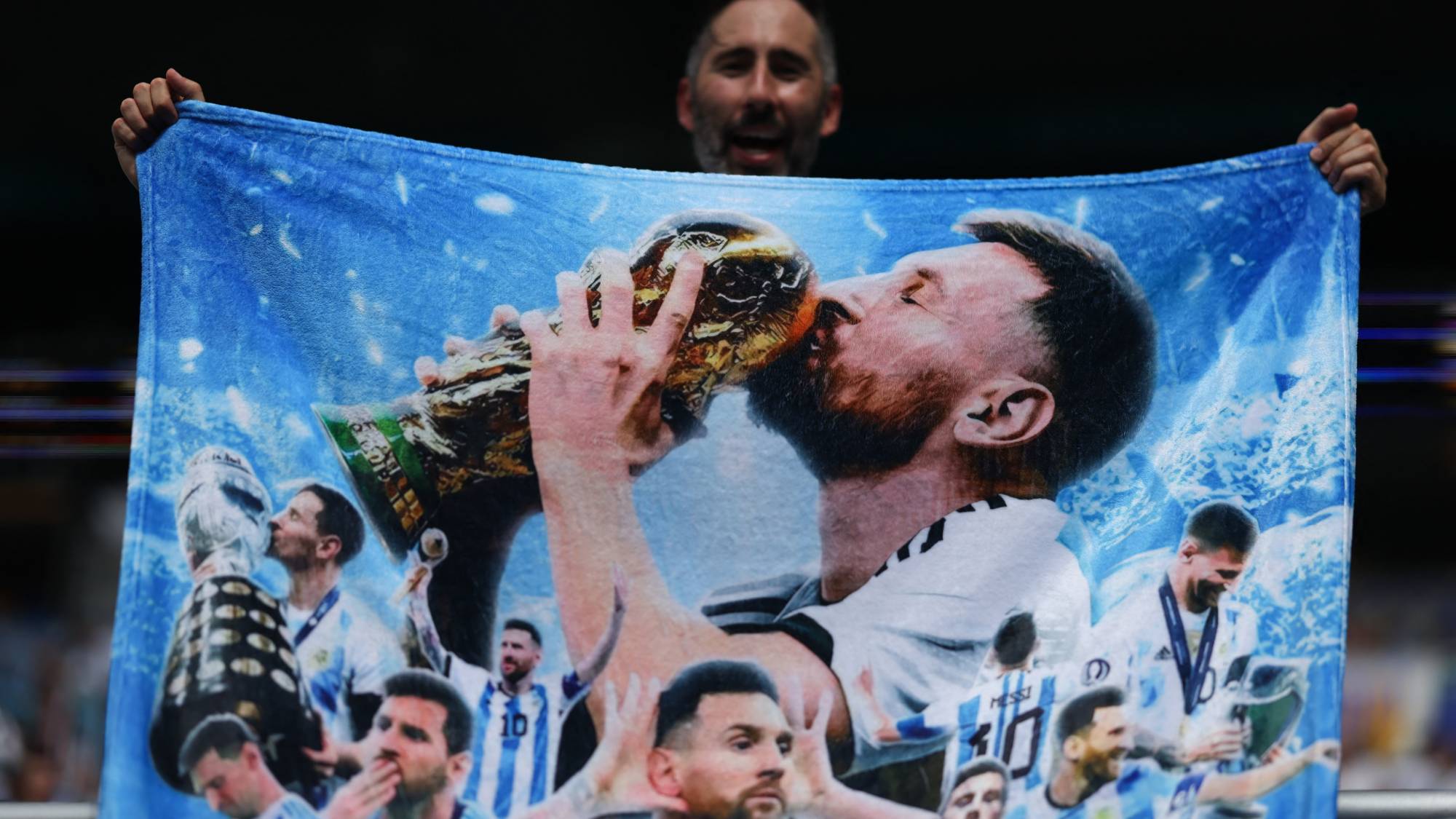 An Argentine fan displays a towel depicting Argentine football player Lionel Messi ahead of the 2026 World Cup round of 32 football match between Argentina and Cape Verde at the Miami Stadium in Miami Gardens on July 3, 2026.