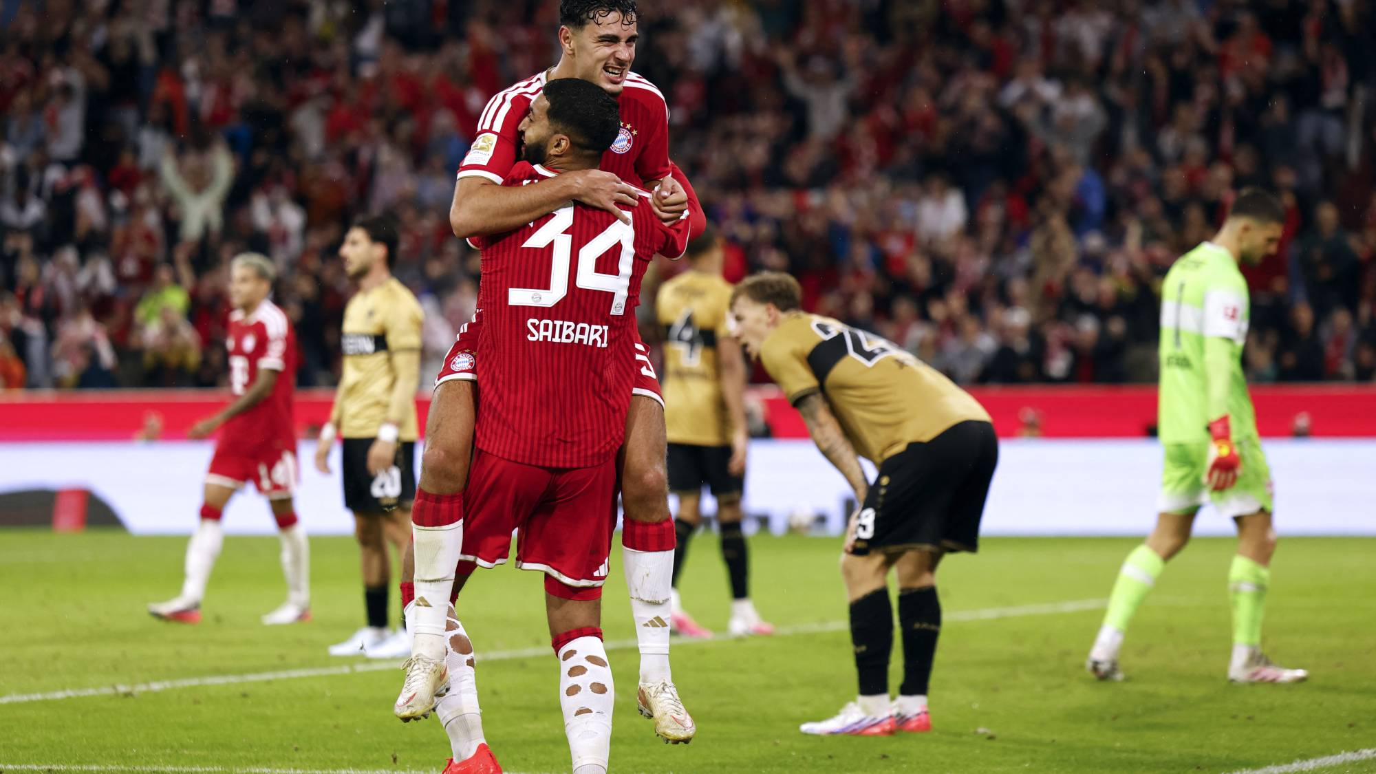 Bayern Munich's German midfielder #45 Aleksandar Pavlovic celebrates scoring his team's fourth goal with Bayern Munich's Moroccan midfielder #34 Ismael Saibari during the German first division Bundesliga football match between FC Bayern Munich and VfB Stuttgart in Munich, southern Germany, on August 28, 2026.