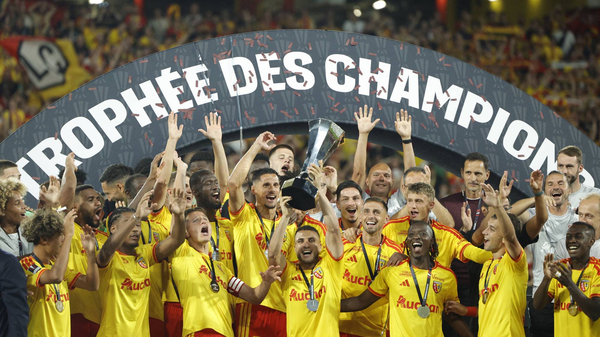Lens' players celebrate with the championship trophy after winning the French Super Cup (Trophee des Champions) football match between RC Lens and Paris Saint-Germain (PSG) at the Stade Bollaert-Delelis in Lens, northern France on August 16, 2026.