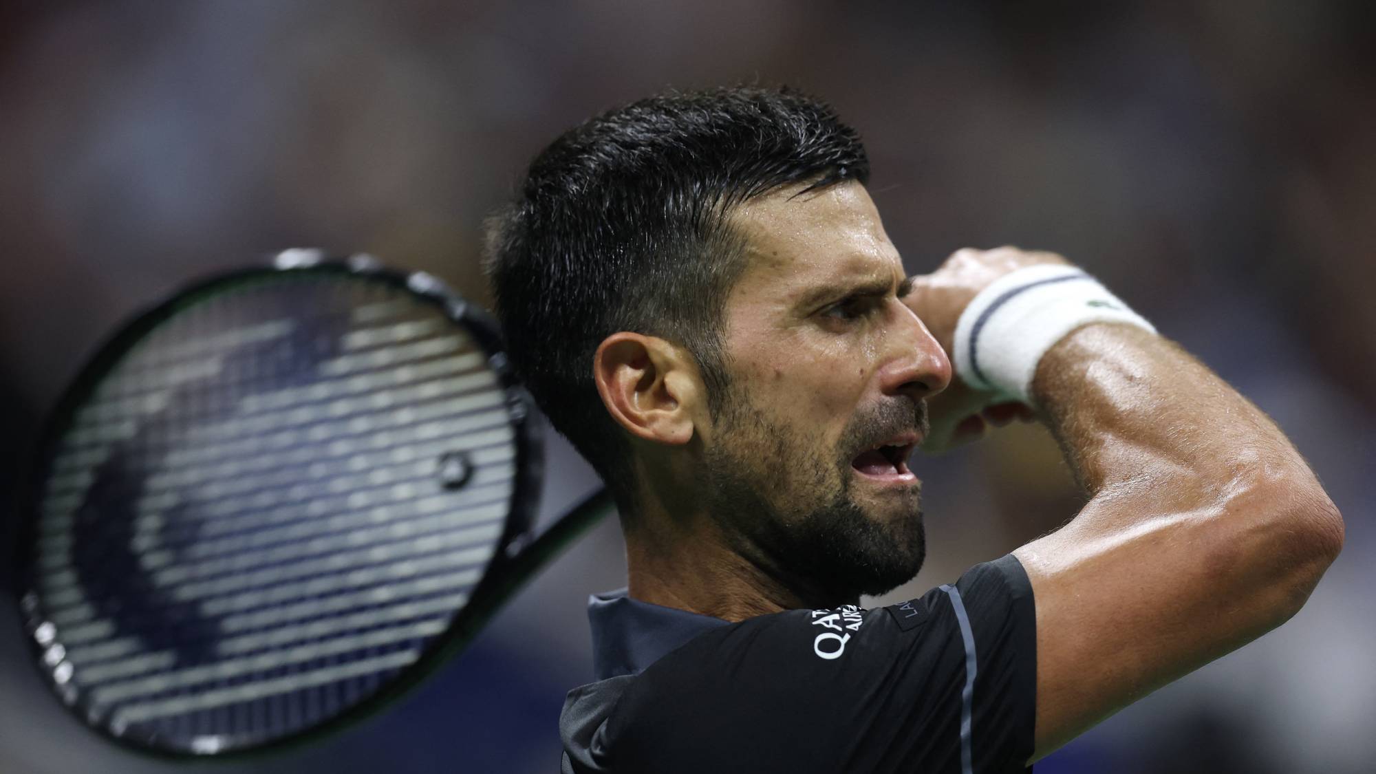 NEW YORK, NEW YORK - AUGUST 30: Novak Djokovic of Serbia returns a shot in his match against Mariano Navone of Argentina during their Men's Singles First Round match on Day One of the 2026 US Open at USTA Billie Jean King National Tennis Center on August 30, 2026 in the Flushing neighborhood of the Queens borough of New York City. Julian Finney/Getty Images/AFP