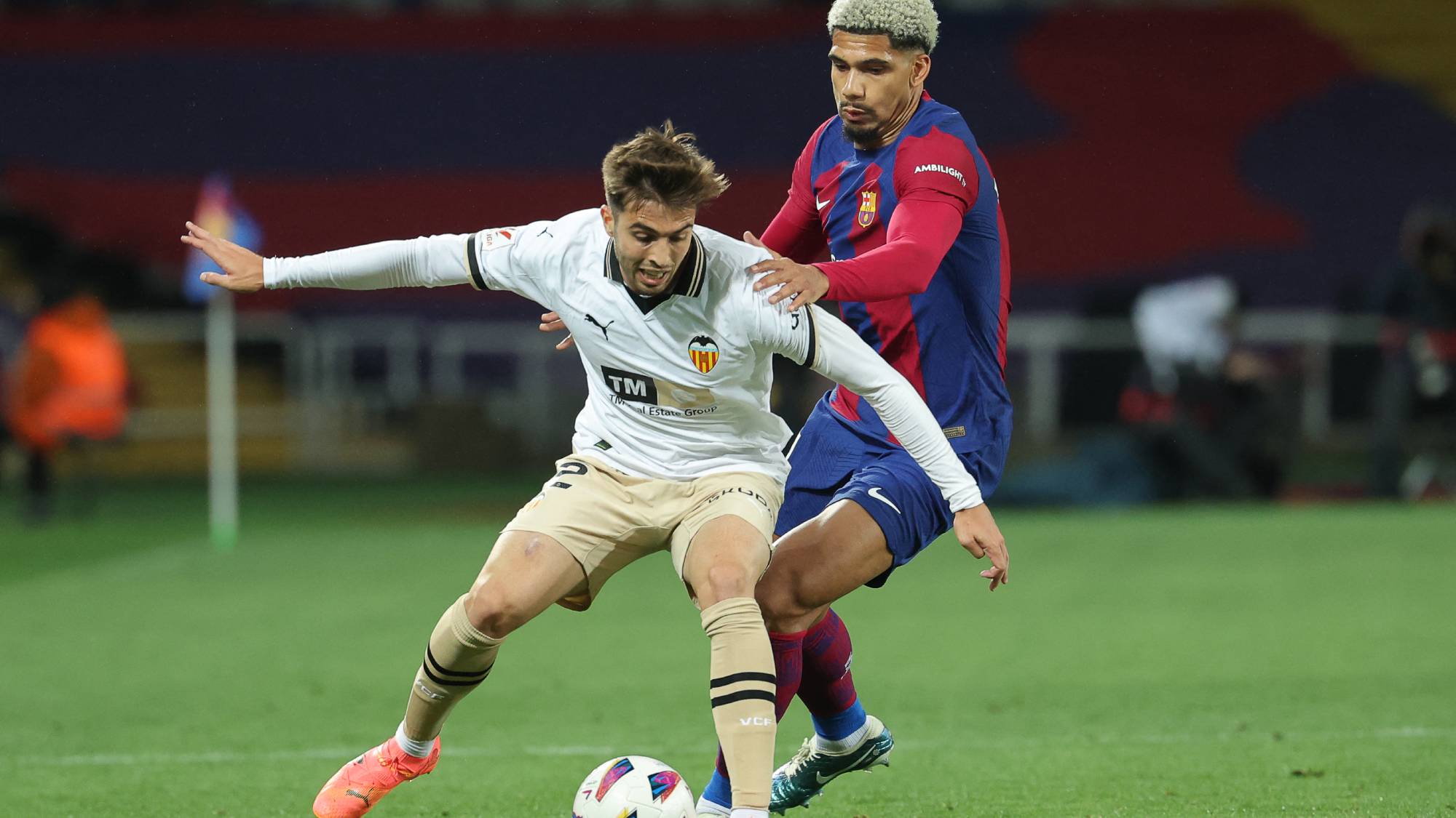 Valencia's Spanish forward #22 Alberto Mari fights for the ball with Barcelona's Uruguayan defender #04 Ronald Araujo during the Spanish league football match between FC Barcelona and Valencia CF at the Estadi Olimpic Lluis Companys in Barcelona on April 29, 2024.