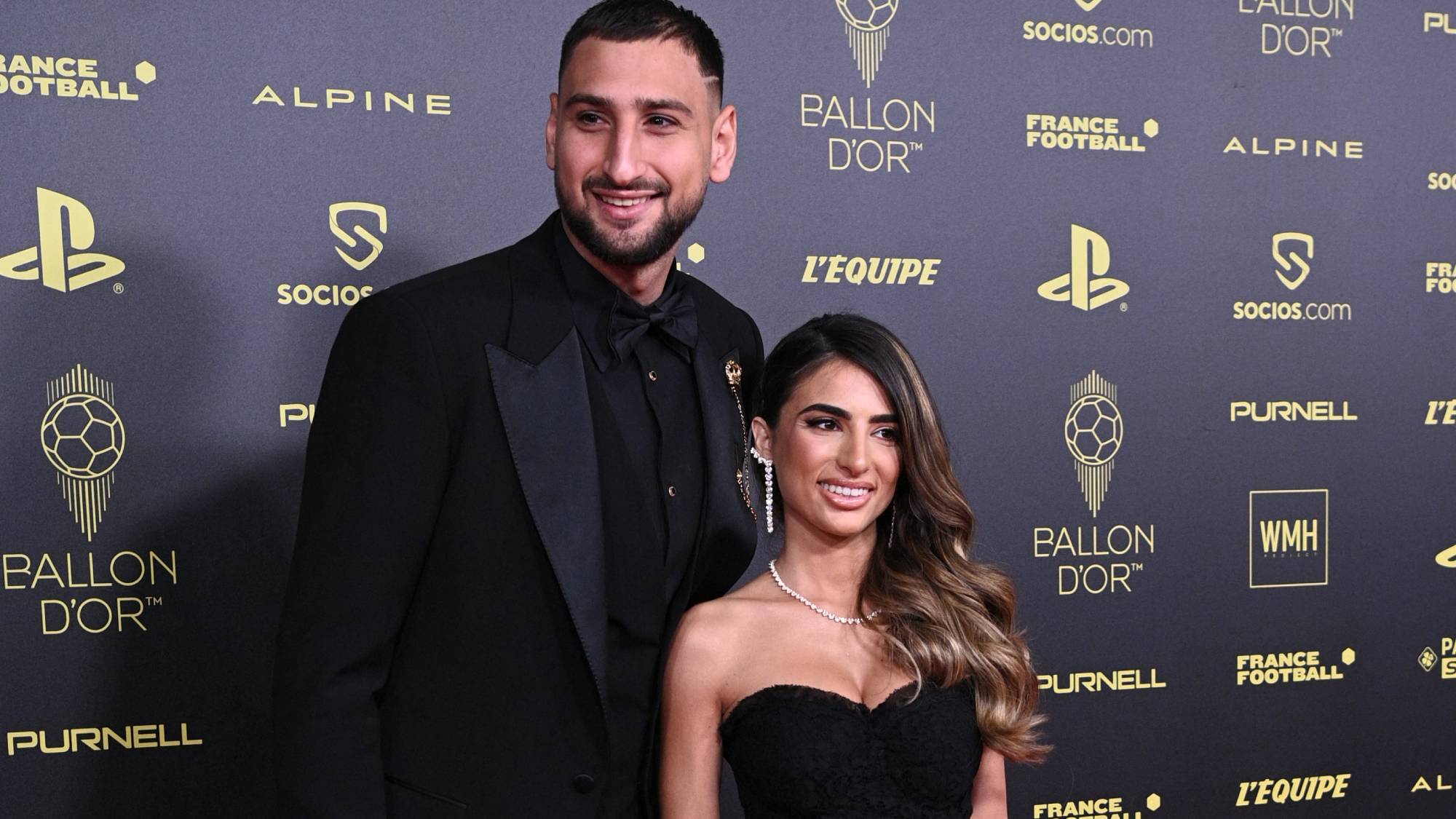 Paris Saint-Germain's Italian goalkeeper Gianluigi Donnarumma (L) and his partner Alessia Elefante pose upon arrival to attend the 2021 Ballon d'Or France Football award ceremony at the Theatre du Chatelet in Paris on November 29, 2021.