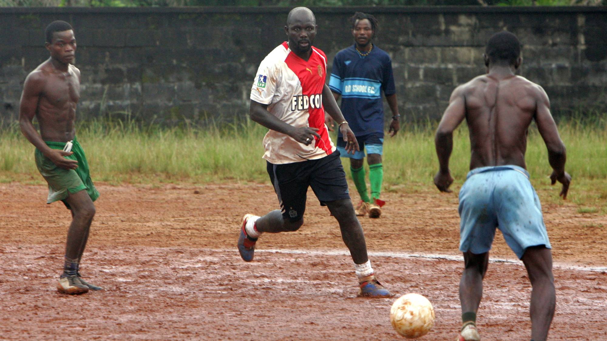 Football legend George Weah practises 18 September 2005 during a training match in Monrovia. War-torn Liberia is three weeks from a vote to choose its first elected government in eight years, with polls showing soccer star Weah losing ground but remaining atop the field of 22 presidential candidates. Though Weah remains the odds-on favorite to take first in the October 11 election if not win an absolute majority, mandating a second round in early November, his closest rivals are closing the gap in the provinces. Weah was the former striker of Paris St. Germain and AC Milan, and the only African ever to win FIFA's Footballer of the Year Award in 1995. An idol in Liberia, where he is known as "King George", Weah has also financed the national football team, called Lone Star, as a vehicle to maintain and develop the footballing infrastructure in the country. AFP PHOTO OLIVIER LABAN-MATTEI