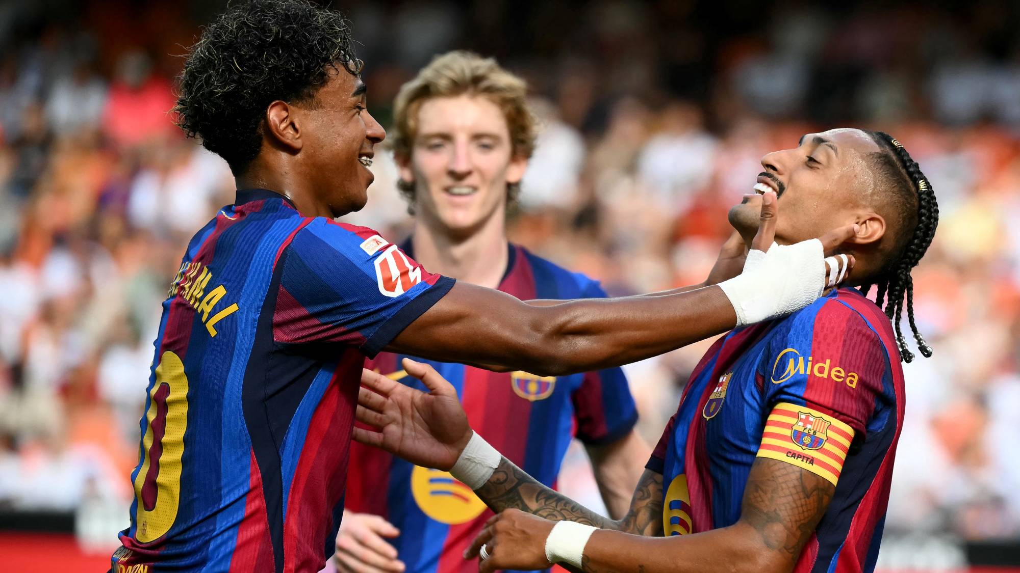 Barcelona's Brazilian forward #11 Raphinha (R) celebrates with Barcelona's Spanish forward #10 Lamine Yamal scoring his team's third goal during the Spanish league football match between Valencia CF and FC Barcelona at Mestalla Stadium in Valencia on September 6, 2026.
