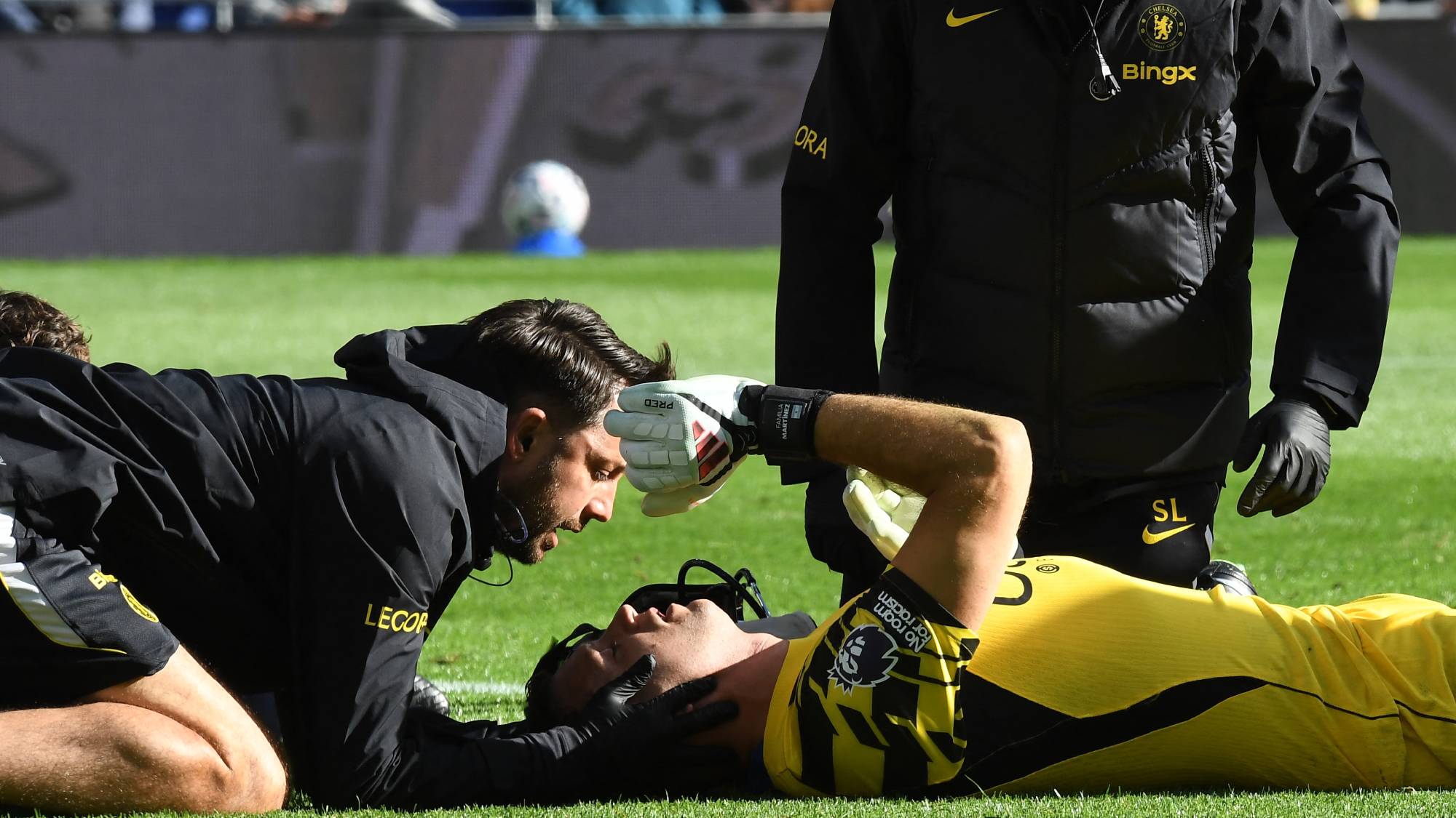 Chelsea's Argentinian goalkeeper #26 Emiliano Martinez is treated after picking up an injury during the English Premier League football match between Everton and Chelsea at Hill Dickinson Stadium in Liverpool, north west England on October 17, 2026.