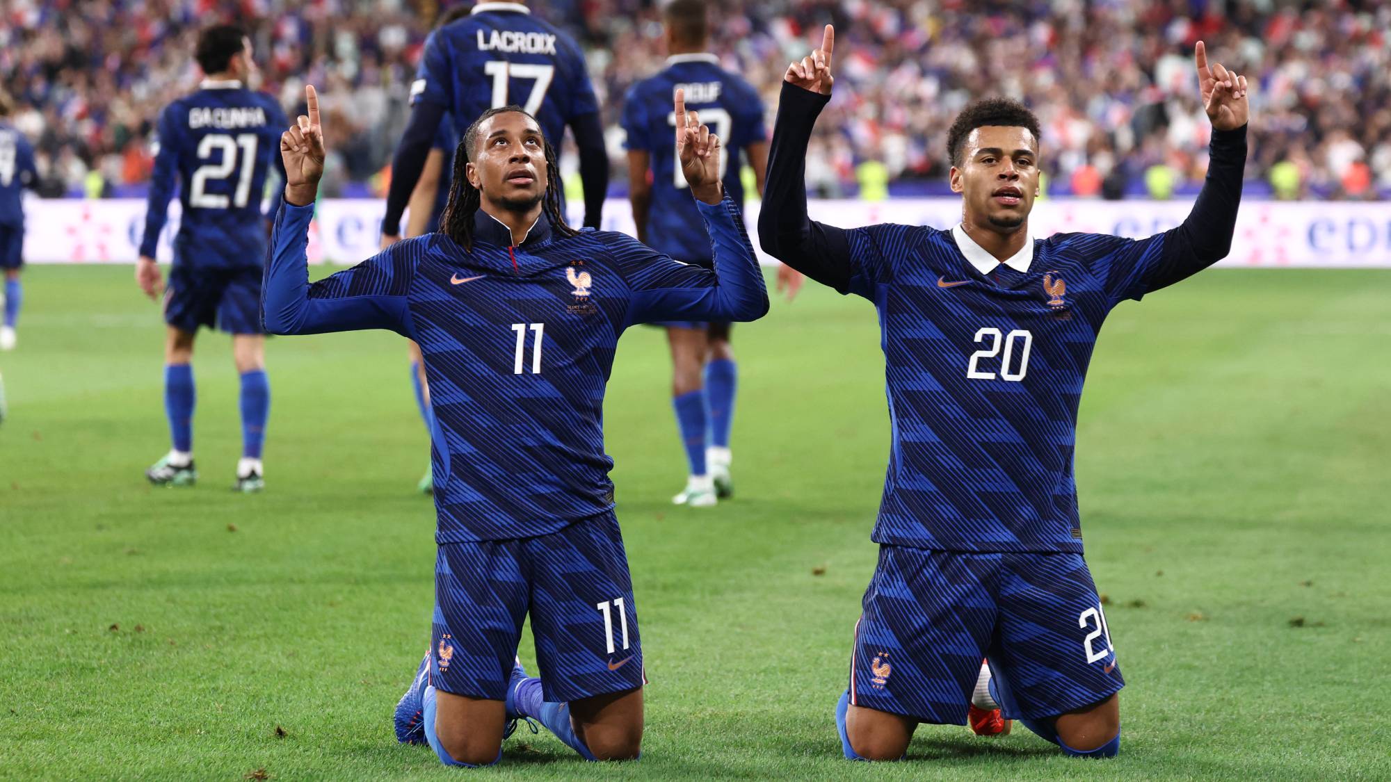 France's midfielder #11 Michael Olise (L) celebrates with France's forward #20 Desire Doue after scoring his team's fourth goal during the UEFA Nations League Group A1 football match between France and Belgium at the Stade de France in Saint-Denis, north of Paris, on October 5, 2026.
