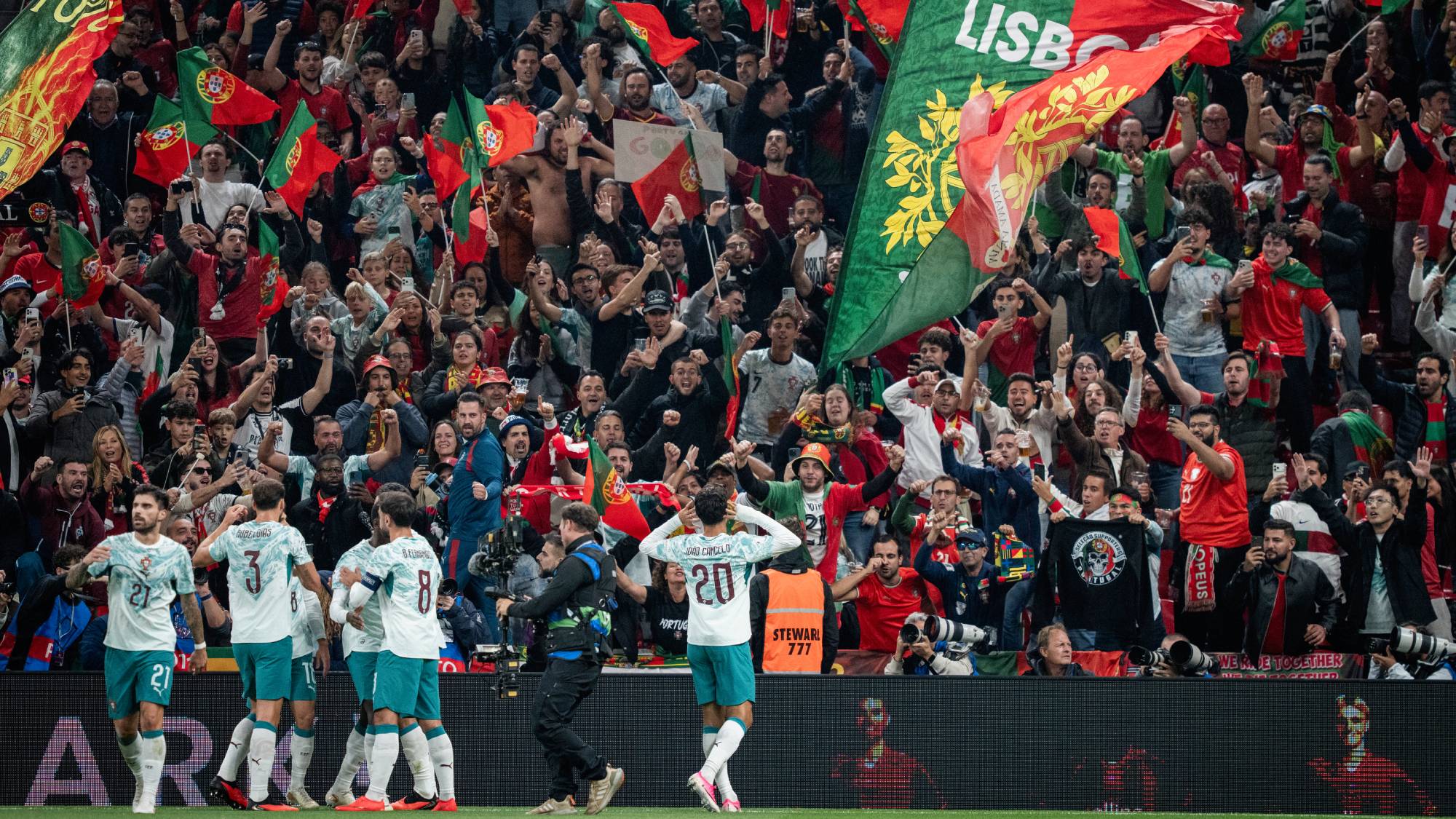 Portugal's defender #20 Joao Cancelo (R) celebrates scoring the opening goal with his teammates during the UEFA Nations League Group A4 match between Denmark and Portugal at Parken stadium in Copenhagen on October 1, 2026.